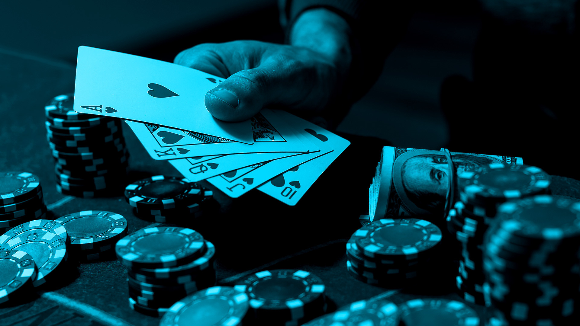 Hand of cards and chips scattered across a table